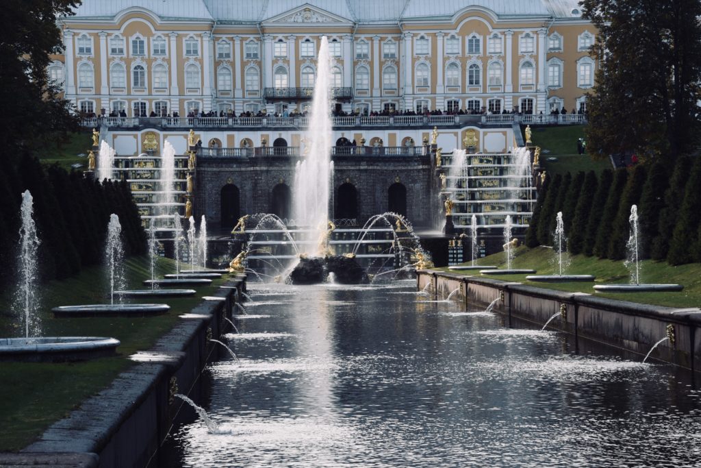 front view of gold statues and water fountain