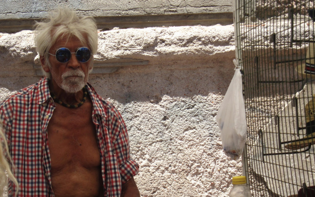 old man beside bird cage
