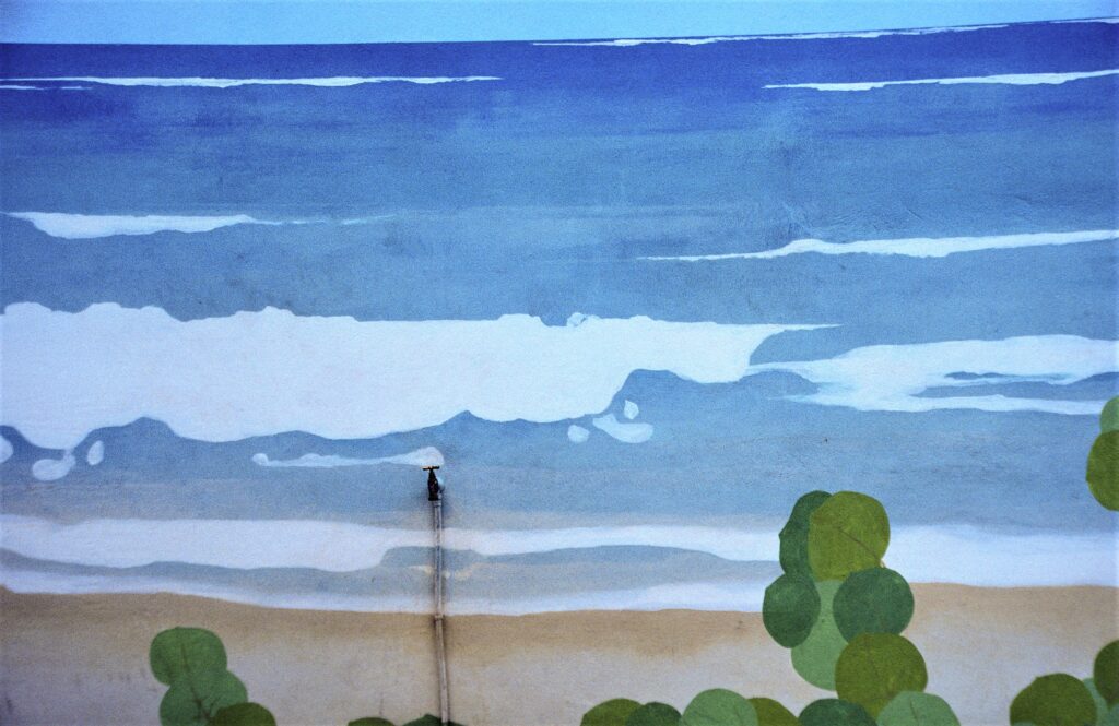 Mural of Ocean with water faucet in the middle
